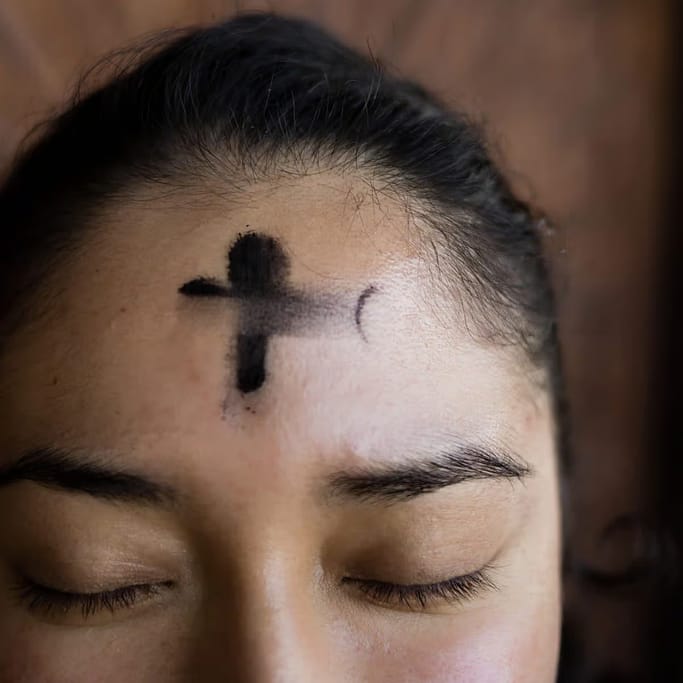 Photo of a woman with Ashes applied to her forehead to depict someone celebrating a Progressive Christian Ash Wednesday.